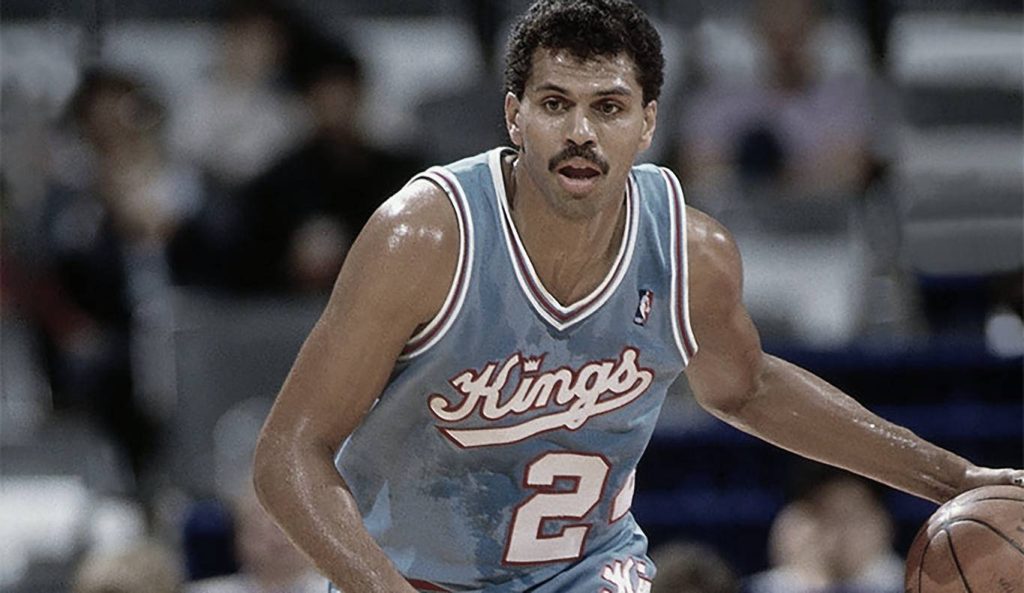 Reggie Theus playing a basketball
